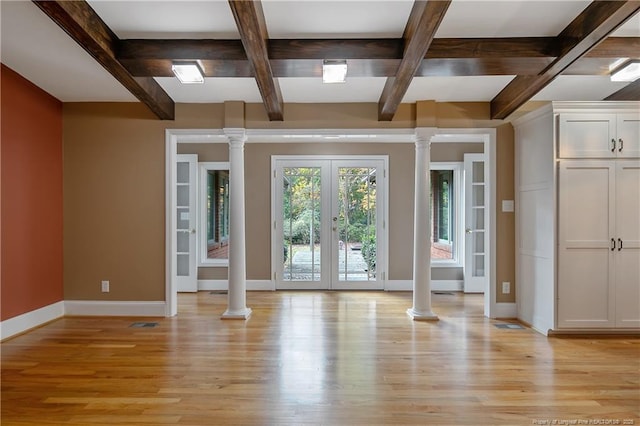 interior space featuring coffered ceiling, decorative columns, and french doors