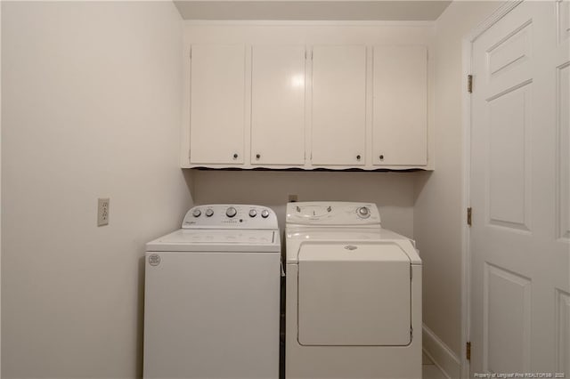 laundry area featuring cabinets and washer and clothes dryer