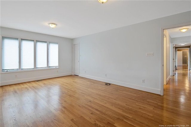 spare room featuring light hardwood / wood-style flooring