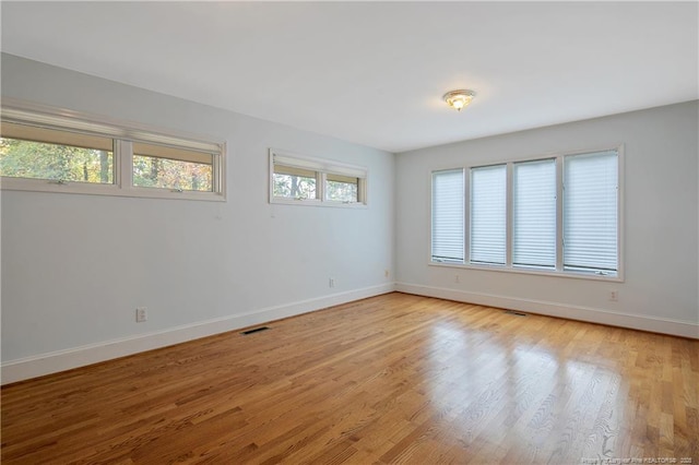 unfurnished room with light hardwood / wood-style floors