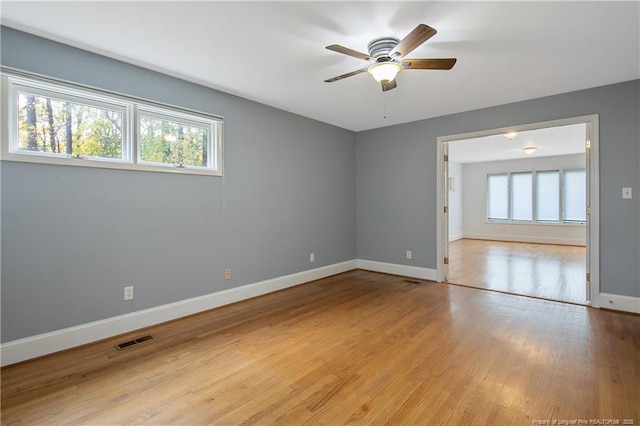 empty room featuring ceiling fan and light wood-type flooring