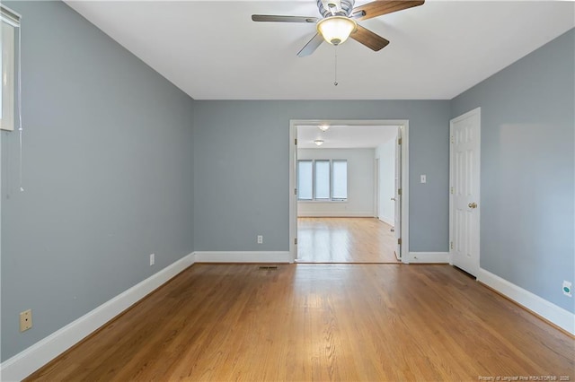 empty room featuring ceiling fan and light hardwood / wood-style floors