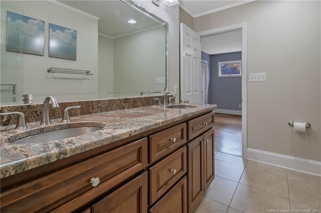 bathroom with tile patterned floors, crown molding, and vanity