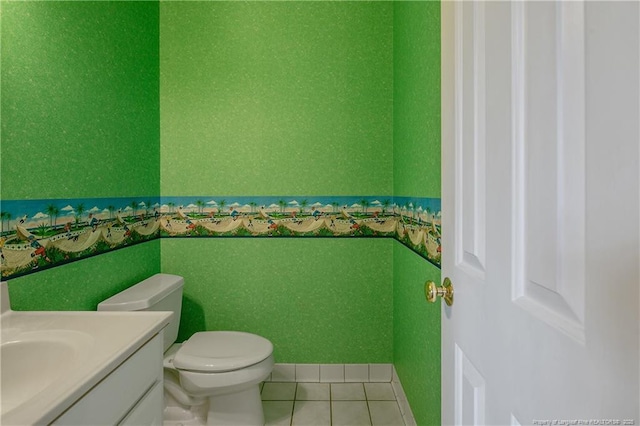 bathroom featuring tile patterned flooring, vanity, and toilet