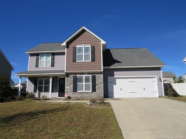 view of front of home featuring a front yard and a garage