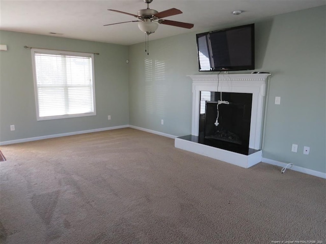 unfurnished living room with carpet flooring and ceiling fan