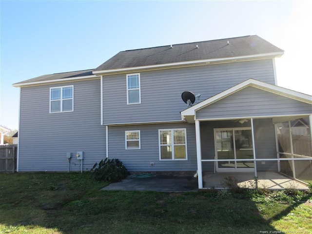 back of house with a yard, a patio, and a sunroom