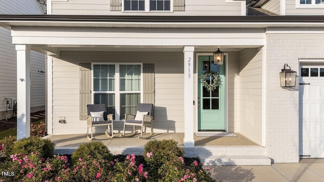 view of exterior entry with covered porch