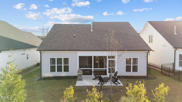 rear view of property with a lawn and a patio area