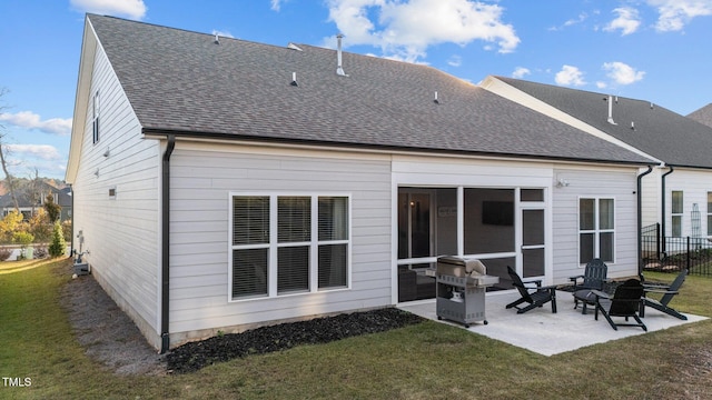 back of house with a lawn and a patio