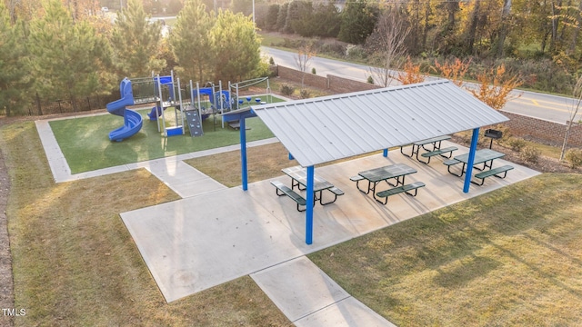 exterior space with a playground and a lawn