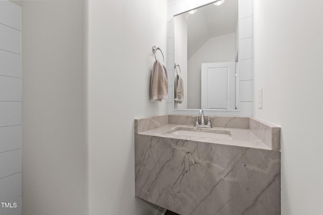 bathroom with sink and vaulted ceiling