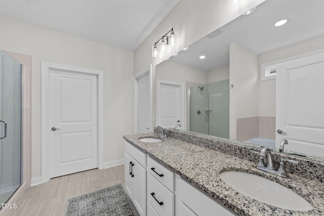 bathroom featuring hardwood / wood-style floors, vanity, and separate shower and tub