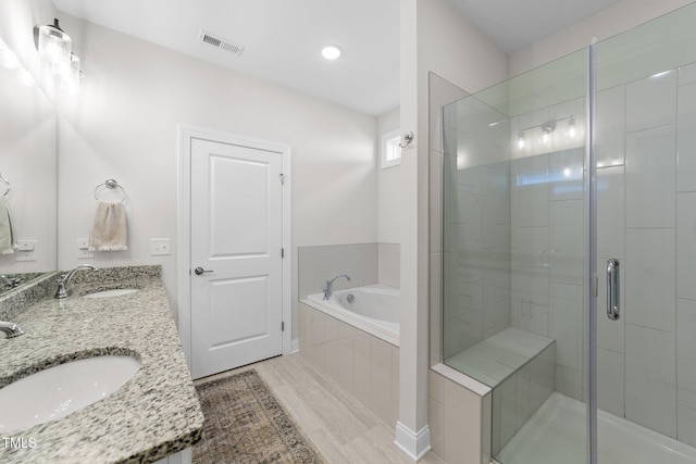 bathroom with wood-type flooring, vanity, and separate shower and tub