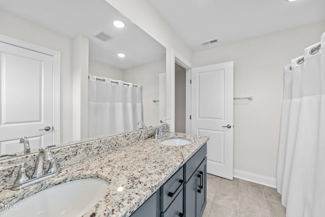 bathroom featuring tile patterned flooring, vanity, and a shower with shower curtain