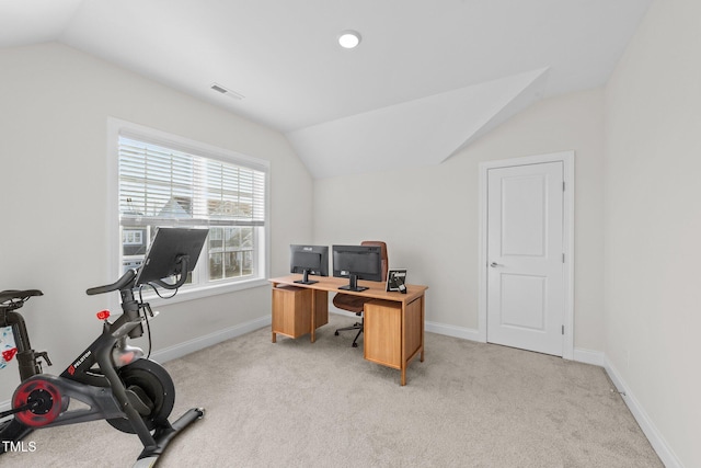 carpeted office space featuring lofted ceiling