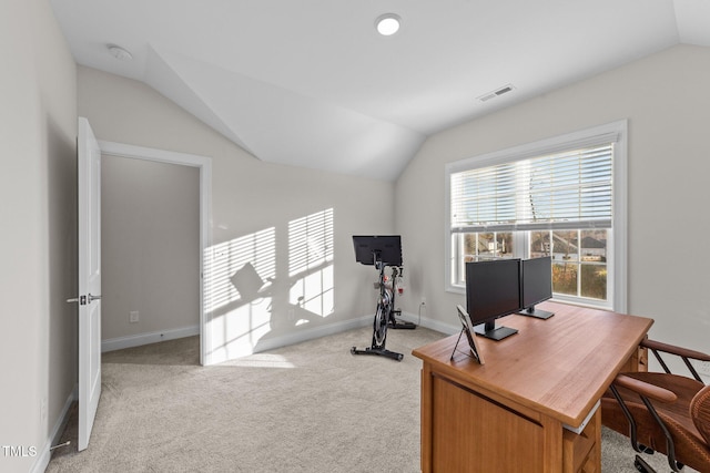 office space featuring light colored carpet and vaulted ceiling