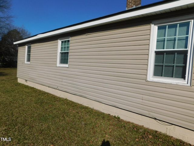 view of side of property with a yard