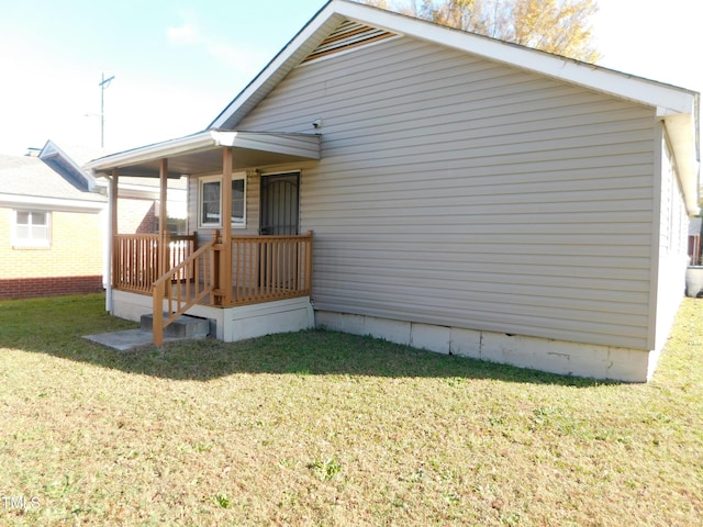 rear view of house featuring a lawn