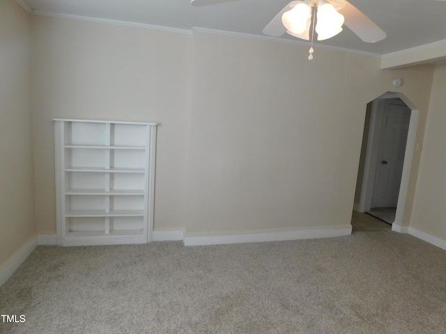 carpeted empty room with ceiling fan and ornamental molding