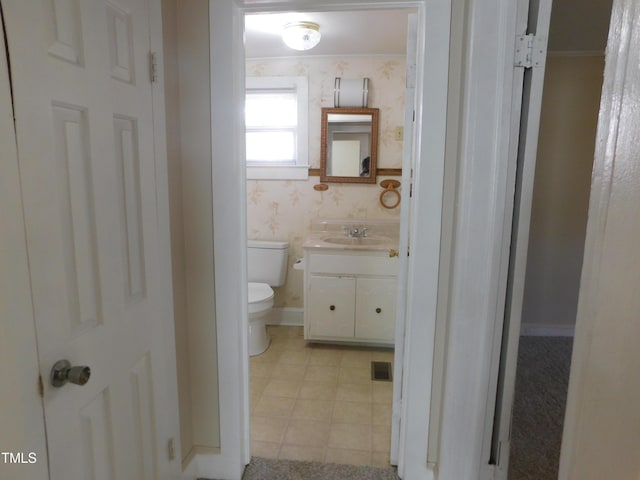 bathroom featuring vanity and toilet