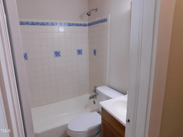 full bathroom with tiled shower / bath, vanity, and toilet