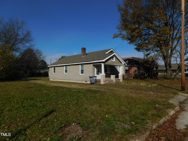 back of house with a lawn