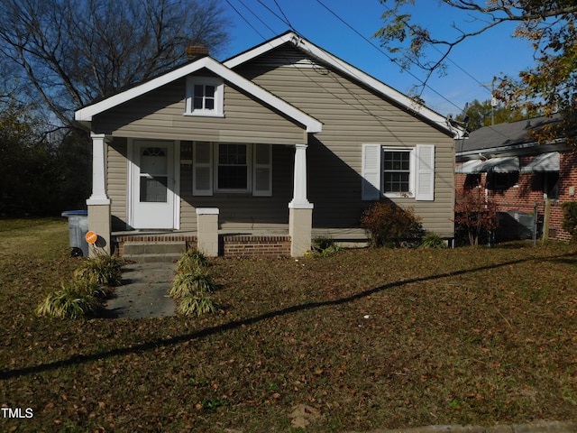 bungalow-style house with a porch and a front yard