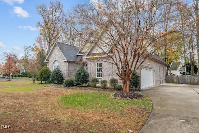 view of front of home featuring a garage and a front lawn