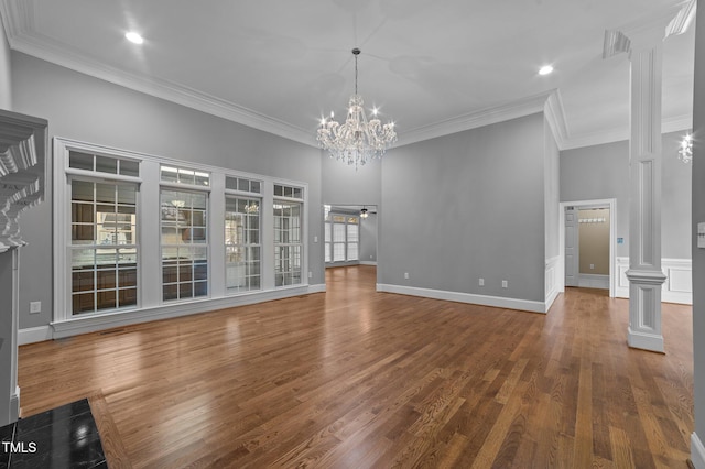 unfurnished living room with dark hardwood / wood-style floors, ornamental molding, and decorative columns