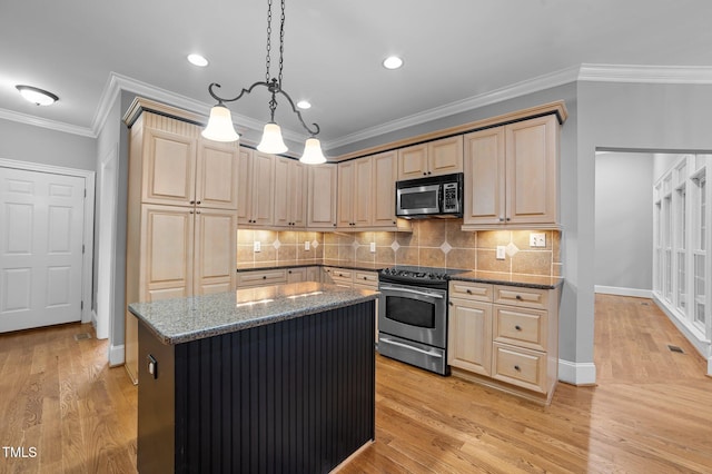 kitchen with appliances with stainless steel finishes, light brown cabinets, light hardwood / wood-style floors, and decorative light fixtures