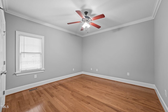 empty room featuring ceiling fan, light hardwood / wood-style flooring, and ornamental molding