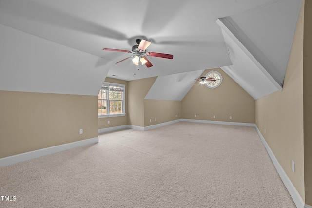 bonus room featuring ceiling fan, lofted ceiling, and light carpet