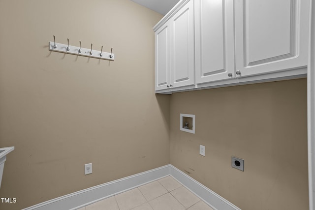 laundry area with hookup for an electric dryer, hookup for a washing machine, light tile patterned floors, and cabinets