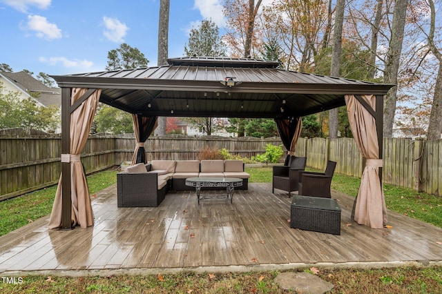 wooden terrace featuring a gazebo and an outdoor living space