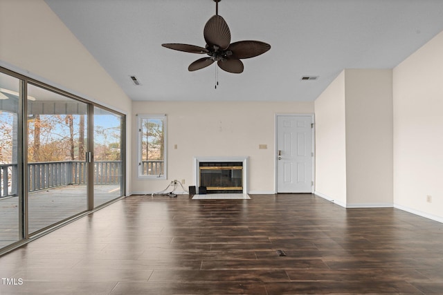 unfurnished living room featuring ceiling fan, dark hardwood / wood-style flooring, and vaulted ceiling