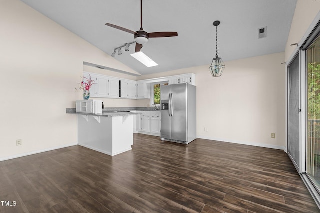 kitchen featuring kitchen peninsula, stainless steel refrigerator with ice dispenser, a kitchen bar, dark hardwood / wood-style floors, and white cabinetry