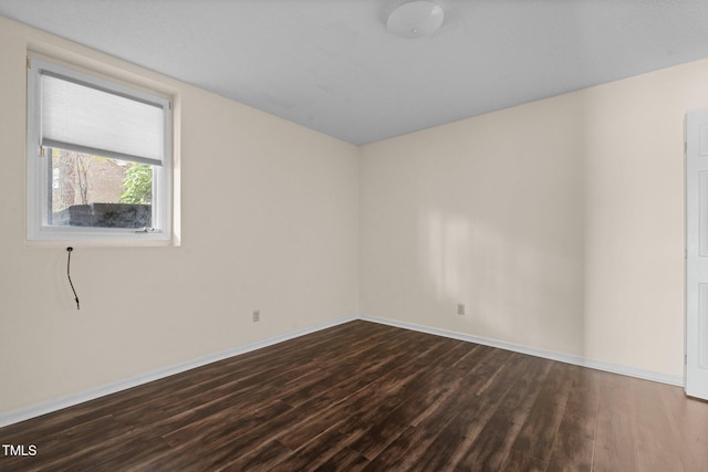 empty room featuring dark wood-type flooring