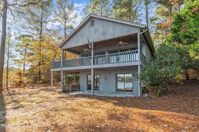 rear view of house featuring ceiling fan and a patio