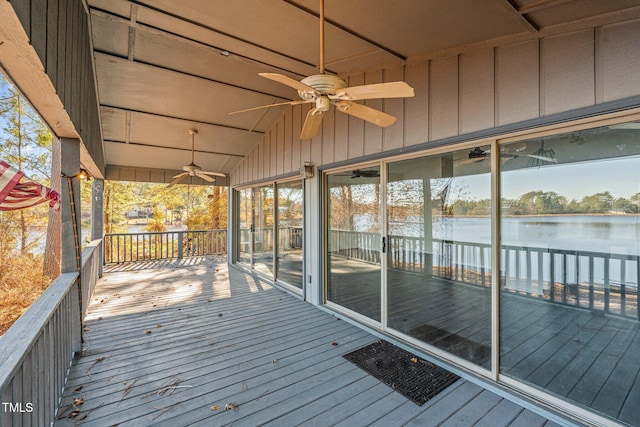 wooden terrace with ceiling fan and a water view