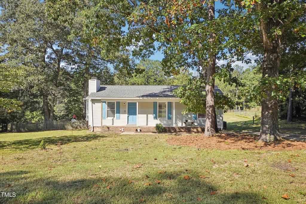 ranch-style house featuring a porch and a front lawn