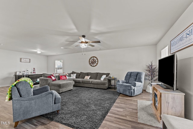 living room with ceiling fan, plenty of natural light, and hardwood / wood-style flooring