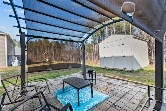 view of patio with a storage unit and a pergola