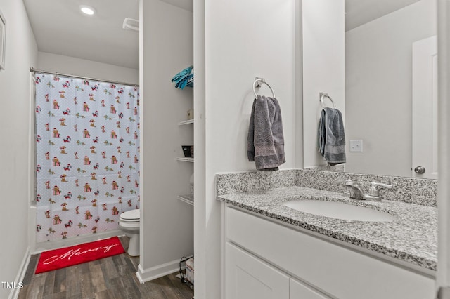 full bathroom with shower / bath combo with shower curtain, toilet, vanity, and hardwood / wood-style flooring