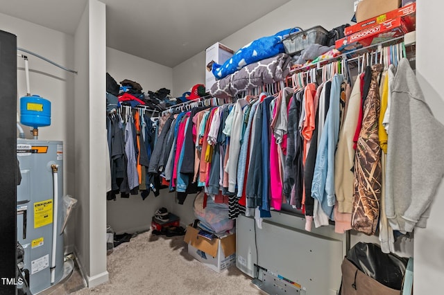 walk in closet with carpet flooring and electric water heater