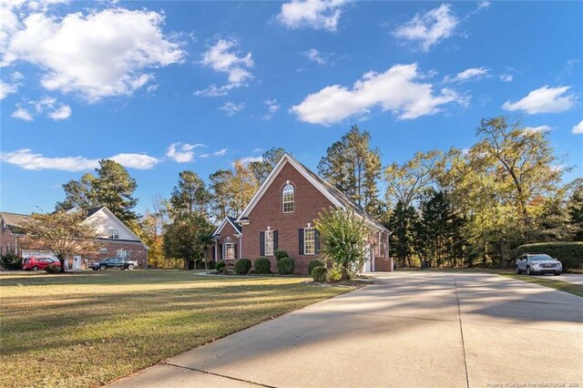 363 Kimberwicke Dr, Fayetteville, NC 28311 - view of side of home featuring driveway, brick siding, and a lawn