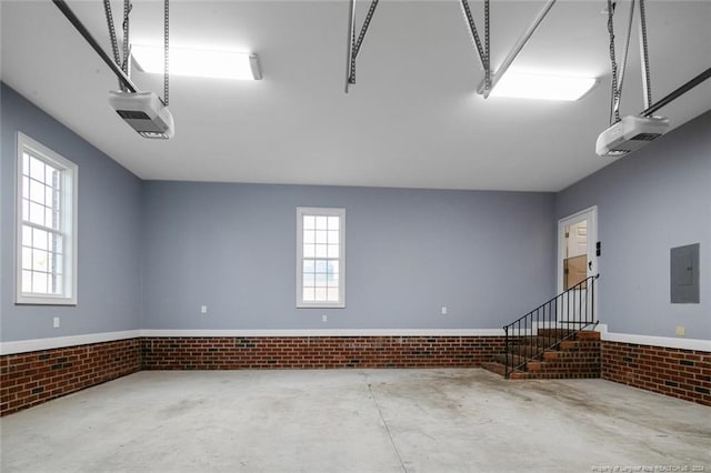 garage featuring electric panel and a garage door opener