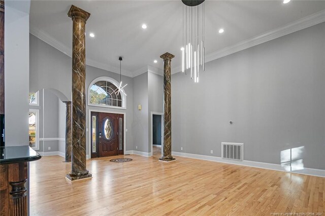 363 Kimberwicke Dr, Fayetteville, NC 28311 - entrance foyer with ornate columns, arched walkways, wood finished floors, baseboards, and recessed lighting