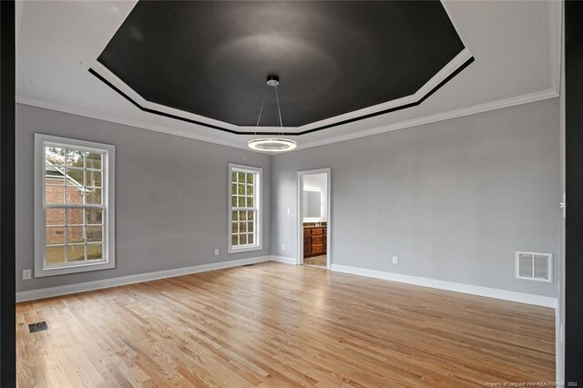 363 Kimberwicke Dr, Fayetteville, NC 28311 - spare room with a raised ceiling, crown molding, light wood-style flooring, and baseboards