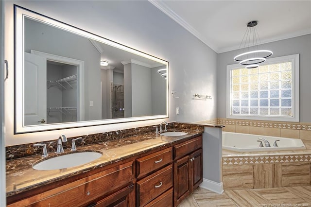 bathroom featuring crown molding, vanity, and a relaxing tiled tub